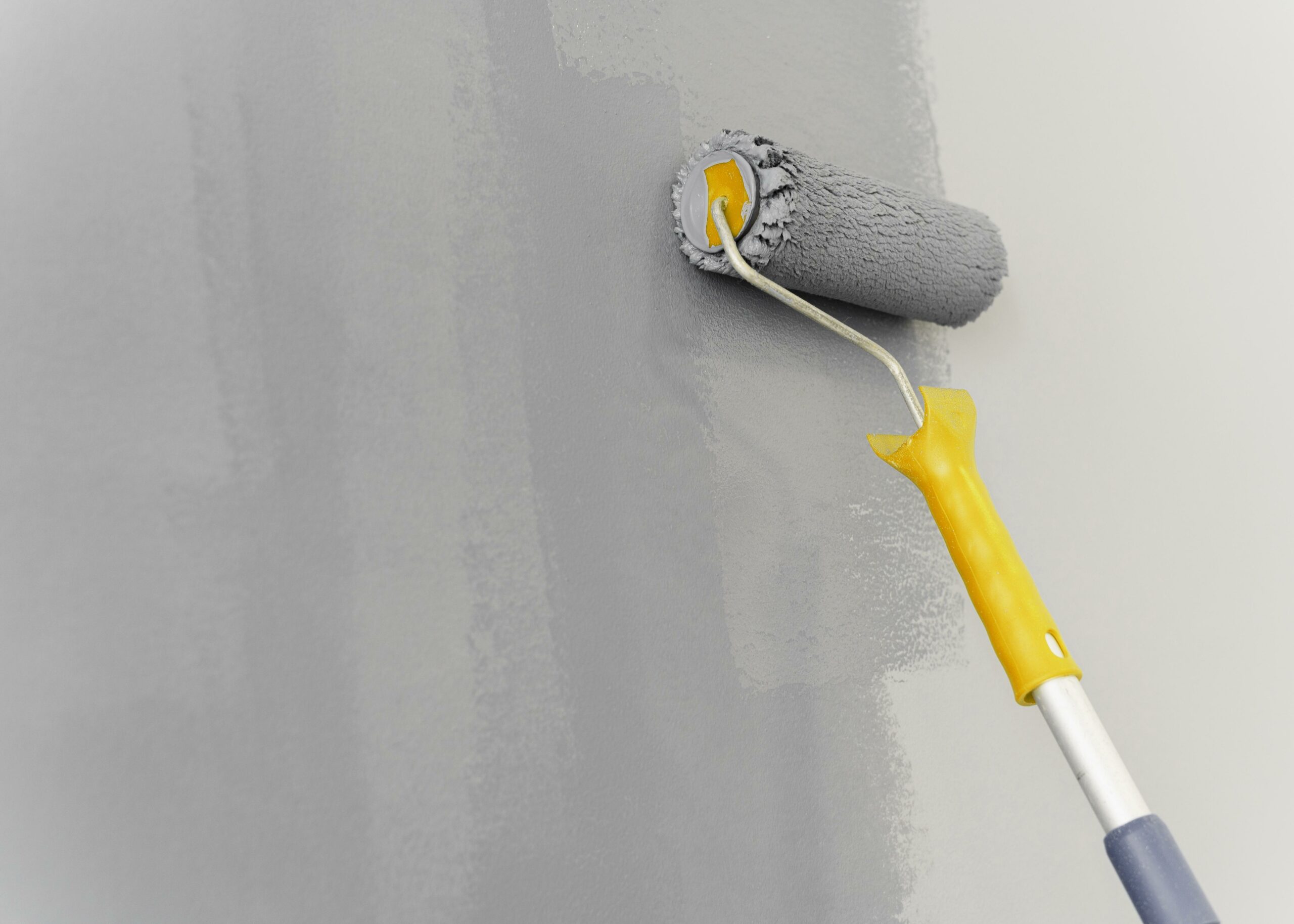 Applying cement wall sealer with roller - enhancing wall protection through expert painting
