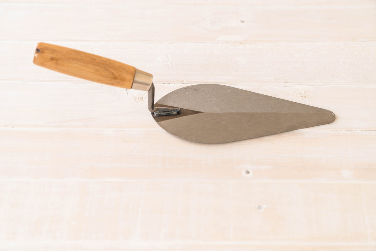 Wood handle gauging trowel on wood